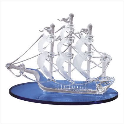 31457: Sailboat On Crystal Seas- Sailing on a glassy blue base, this spun-glass ship is a lovely gift for lovers of the sea. 5 1/2\" x 2 1/2\" x 4\" high. Retail Price:$19.95